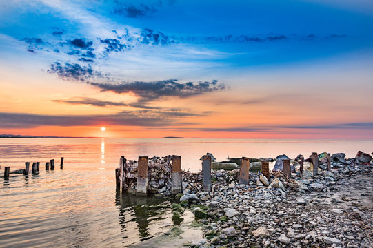 Beautiful landscape  at the sunset with stones over the Razim Razelm lake, Sarichioi, Tulcea, Romania