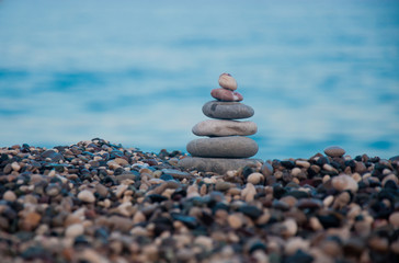 Stack of round smooth stones on a seashore
