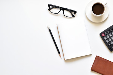 Flat lay style, Top view office desk create on white background with copy space has notebook, pencil, glasses, wallet, calculator and black coffee is elements.
