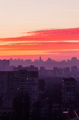 Fototapeta na wymiar Sunset in Kiev, evening view of the panorama Kiev city. Red clouds in the capital of Ukraine