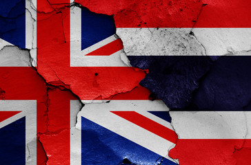 flags of Great Britain and Thailand painted on cracked wall