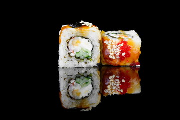 roll with eel and philadelphia cheese on a black background with insulation and reflection