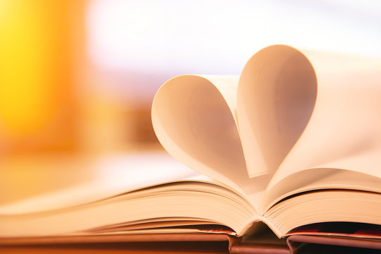 Close up book image in heart shape on the table at library room of lifestyle love to read and february valentine day concepts.