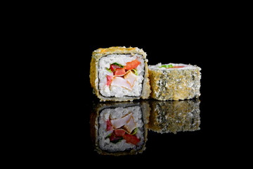 tempura roll with salmon on a black background with insulation and reflection