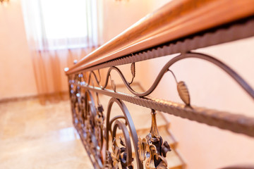 wrought iron staircase in the cottage. Marble steps, black wrought iron stairs with floral...