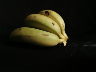 bunch of bananas on black background