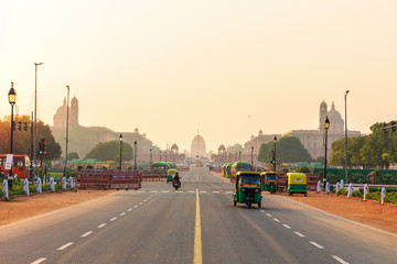 Sunset traffic in New Delhi, tuc tuc cars on the road to the Presidential Residance