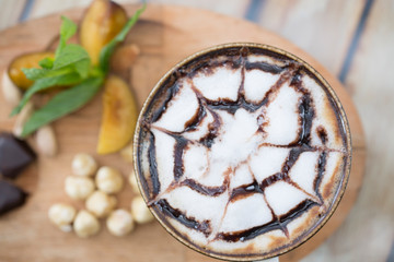 cup of coffee and nuts on wood table