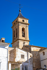Fototapeta na wymiar The church tower of Iglesia del Salvador seen from the Plaza de Albornoz Square in Requena, Spain