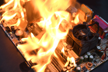 Fire Burning ,blazing computer motherboard, cpu,gpu and video card, processor on circuit board with...