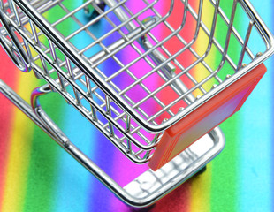 shopping trolley on colorful background