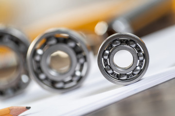 Three various ball bearings lying on paper sheet