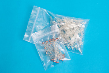 Two plastic bags with LEDs on blue background