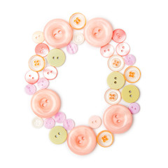 Letter O from pink and green buttons isolated on white background. Sewing kit. Colorful buttons, stylish alphabet for handmaking hobby. Handmade sew abc. Text from buttons