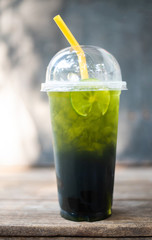 Green tea lemon on grey background.