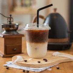 Iced coffee in plastic mugs on a wooden table