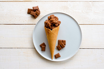 Ice cream on a wooden background. Waffles and chocolate
