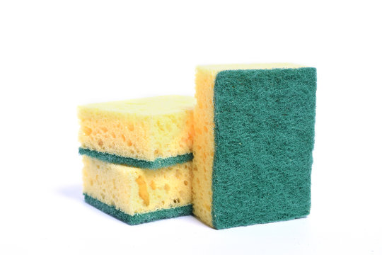 A yellow kitchen sponge isolated against white background in different poses.