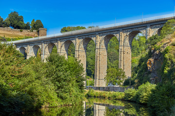 Fototapeta na wymiar Image of the stone road viaduct over the Canal d'ille du Rance at Dinan, Brittany, France