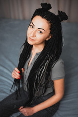 Portrait of a beautiful cool girl with Senegalese pigtails twists very cool