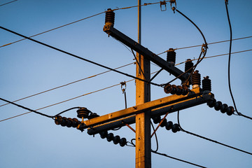 pole and wires on background of blue sky