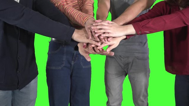 Close up of young people joining their hands