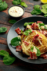 Oven roasted cabbage steaks with bacon, spinach and mayonnaise. healthy food