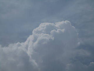 a group of white clouds together in the blue sky