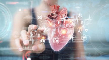 Woman using digital x-ray of human heart holographic scan projection 3D rendering