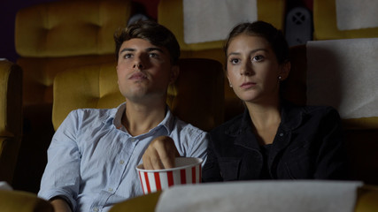 People audience watching movie in the movie theater cinema. Group recreation activity and...