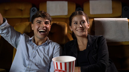 People audience watching movie in the movie theater cinema. Group recreation activity and...