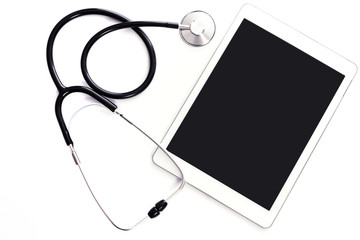 Modern medical treatment template - top view of a blank tablet and a stethoscope  on a white background with copy space