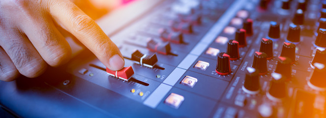 ็Music mix studio concept, hand control mixing sound console for good sound in concert,...