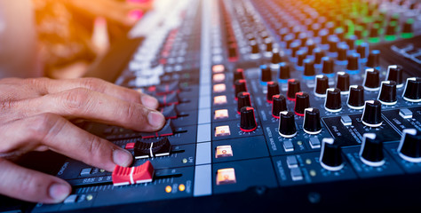 ็Music mix studio concept, hand control mixing sound console for good sound in concert,...