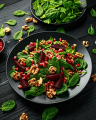 Healthy Beet Salad with fresh sweet baby spinach, pomegranate seeds and candy walnut. healthy Vegan vegetarian, plant based food