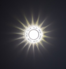 A decorative light glows on the ceiling