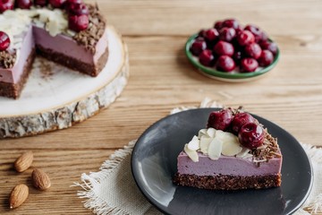  Cherry cake on a wooden background. Almonds in a raw dessert.
