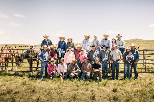Group foto of cowboys and cowgirls who took part in a branding. Cody, Wyoming, USA