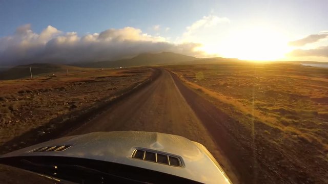 Stunning car mount first person pov on driving fast on dirty rural road in evening sunset desert mountain hill landscape
