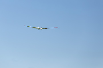 Flying glider in the blue sky