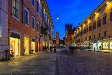 Obraz na płótnie Canvas Old street with Pallazzo Communale (Palazzo Municipale) at night in Ferrara, Emilia-Romagna, Italy. Ferrara is capital of the Province of Ferrara