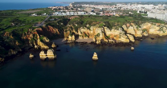 Aerial drone video of the beautiful Camilo Beach (Praia do Camilo) with the sea and cliffs, in Lagos, Algarve, Portugal