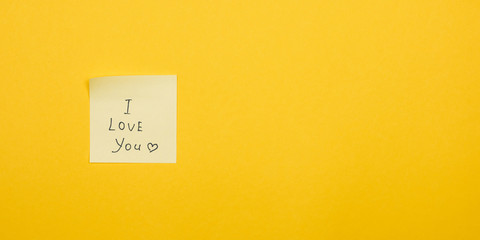 i love you. yellow sticky note on yellow background with copy space