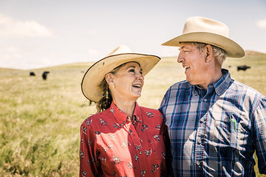 Portrait of older western couple in the prairie after a branding. Cody, Wyoming, USA