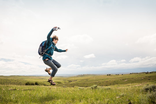 Young boy hiking through rural prairie setting. Cody, Wyoming, USA