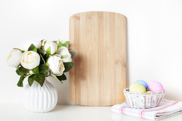 Frame mock up and plants in a vase on on the table. White colors. Greeting card. Background with copy space.