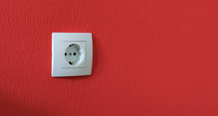 simple single white electricity socket in the wall at home apartment