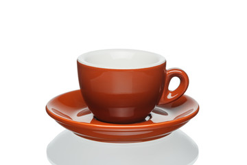 Brown porcelain espresso cup and saucer isolated on a white background.