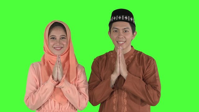 Happy couple congratulates Eid Mubarak at camera