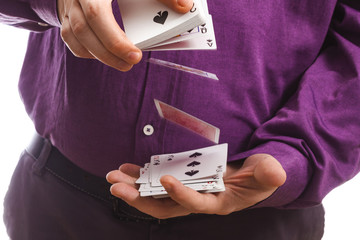 a full man in a purple shirt shows turning over a deck of cards on a white background copy space isolate